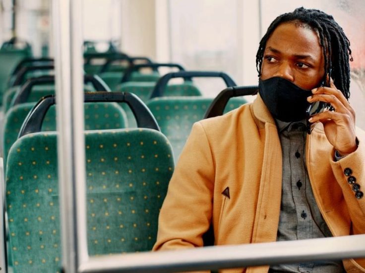 man wearing mask on train