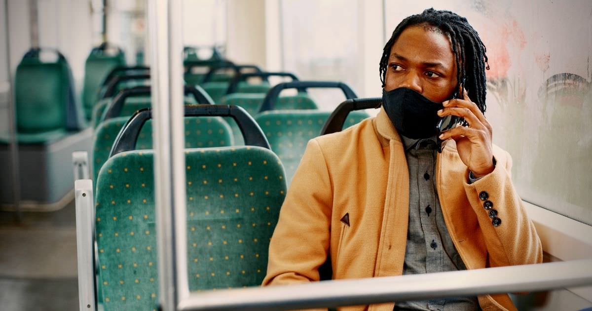 man wearing mask on train